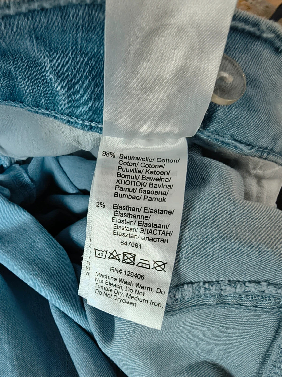 Rainbow blue straight jeans with unique overlapping waistband and two-button closure.