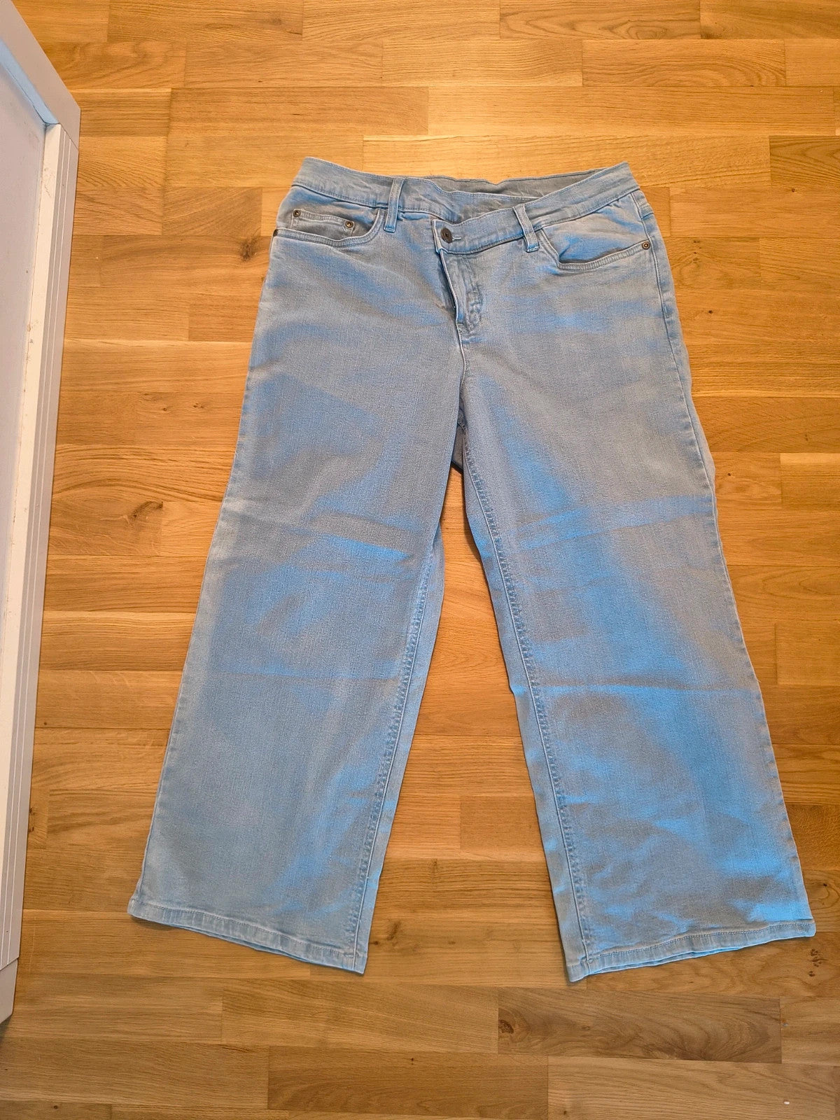 Rainbow blue straight jeans with unique overlapping waistband and two-button closure.