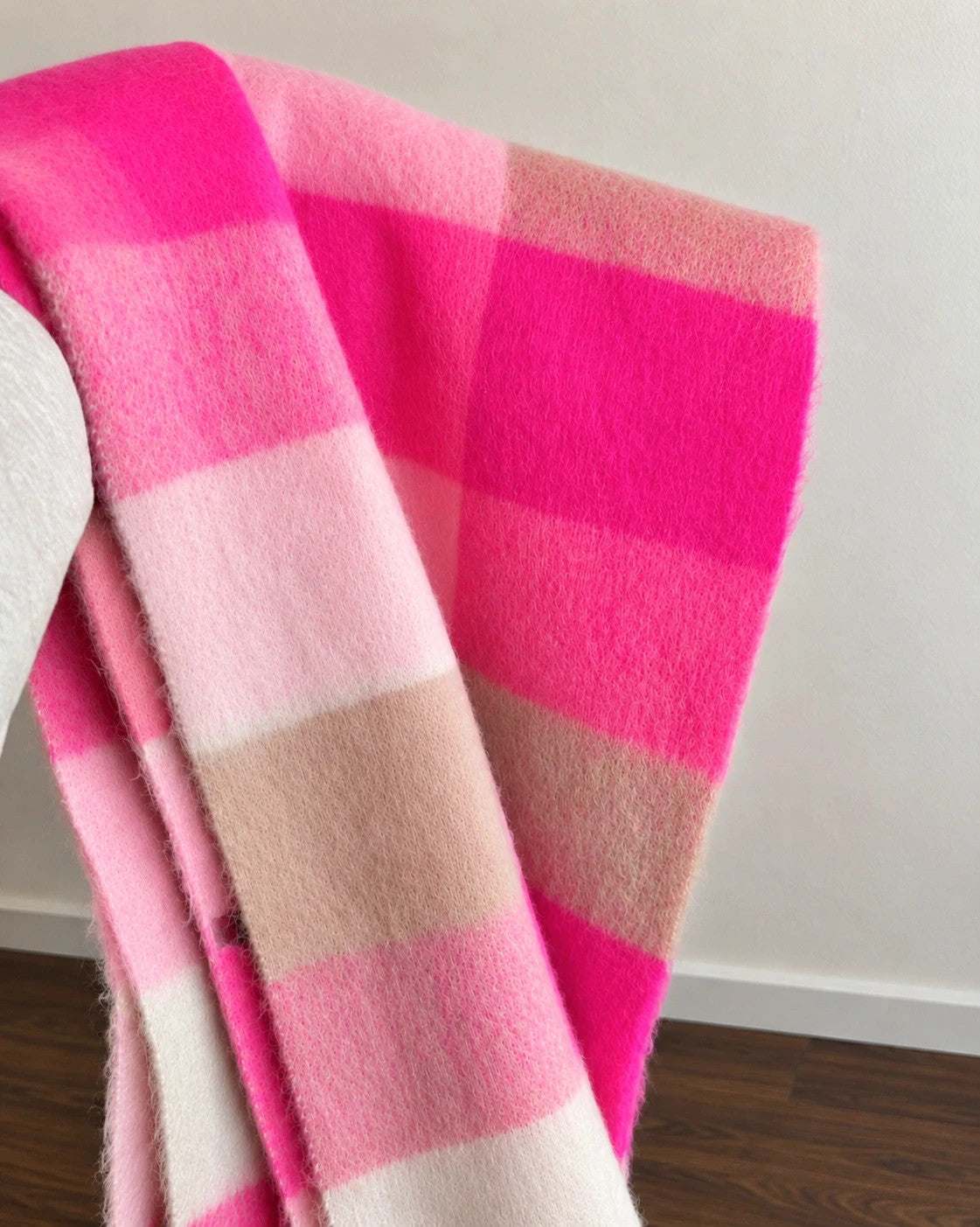 XXL oversized shawl in pink, cream, and beige with large check pattern and fringes.