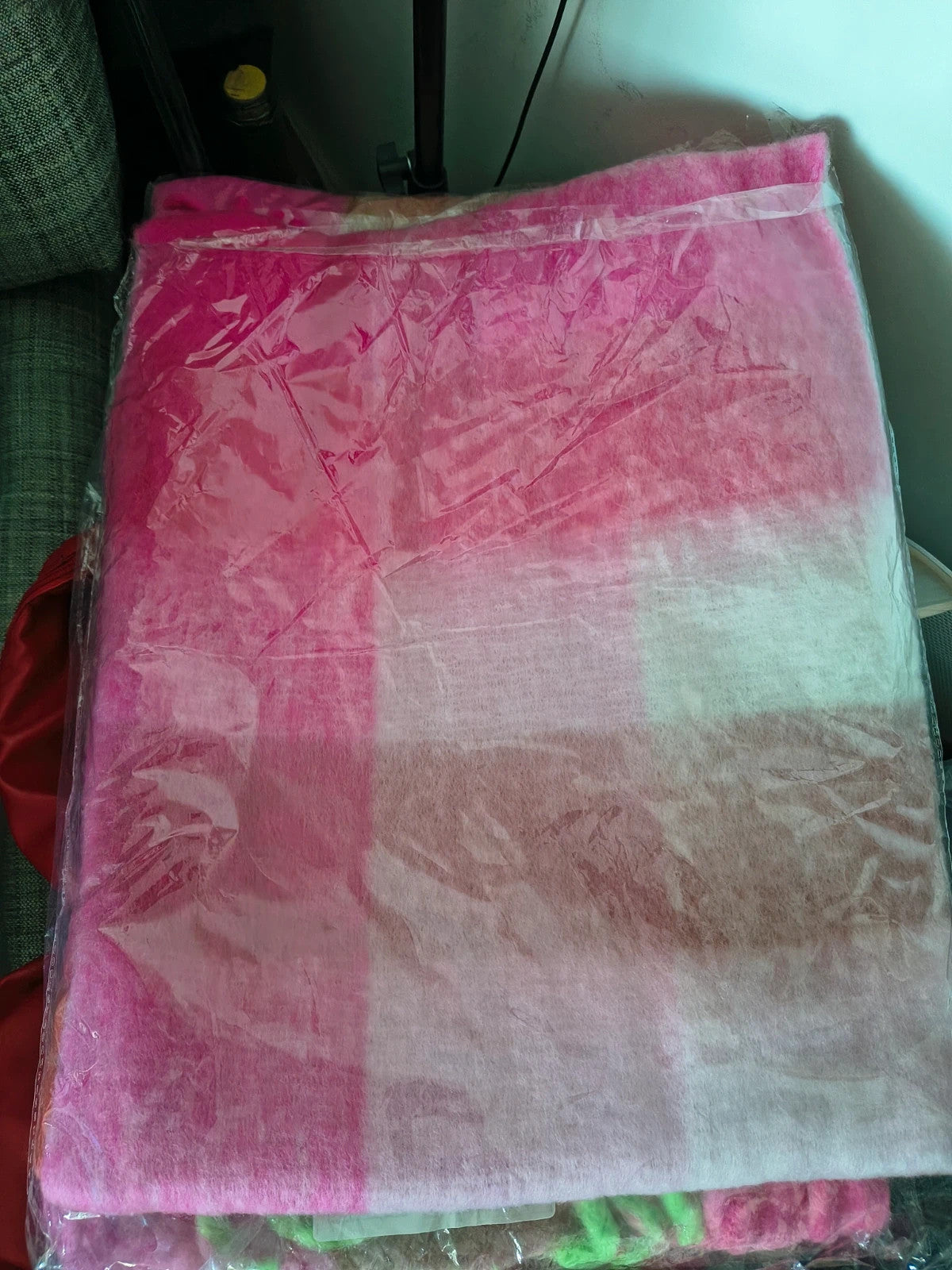 XXL oversized shawl in pink, cream, and beige with large check pattern and fringes.