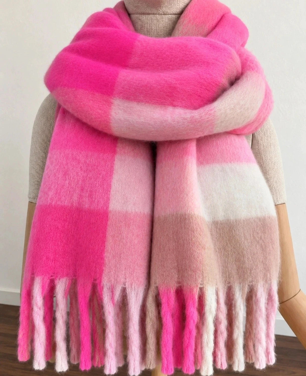XXL oversized shawl in pink, cream, and beige with large check pattern and fringes.