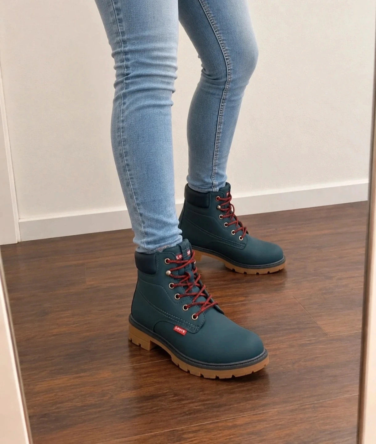 Levi's blue junior boots with contrasting laces, padded shaft, and rugged sole.