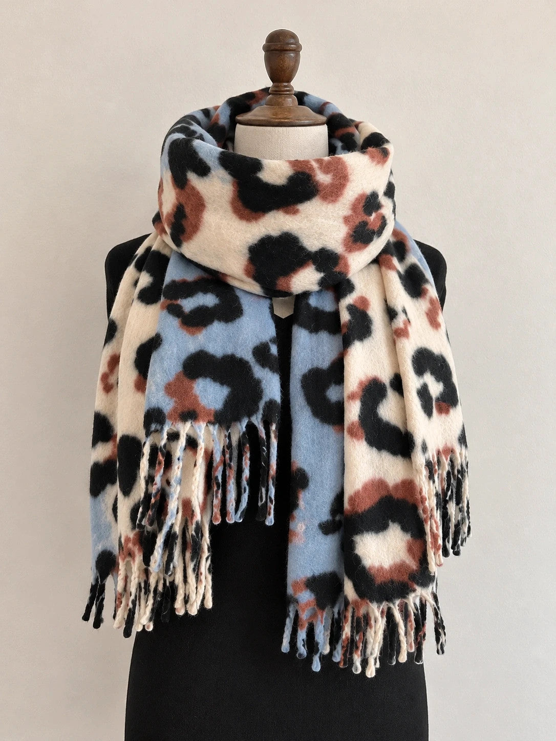XXL multi shawl featuring plush leopard print in cream, light blue, black, and brown.