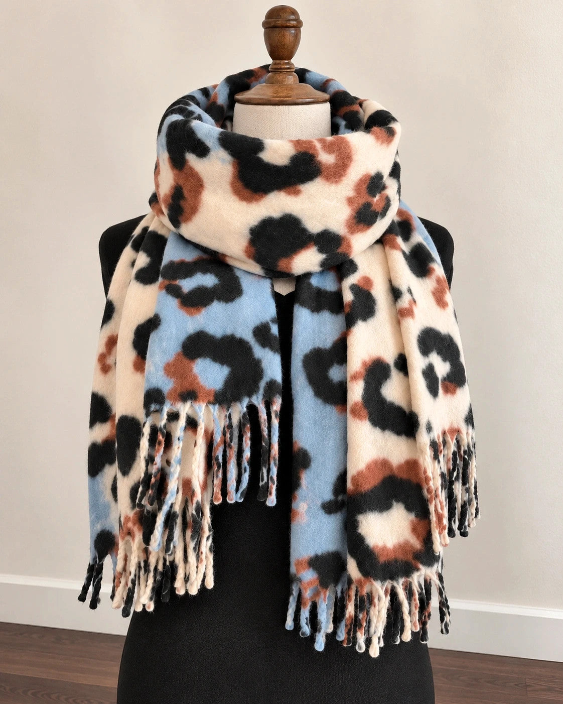 XXL multi shawl featuring bold leopard print in cream, light blue, brown, and black with fringe.