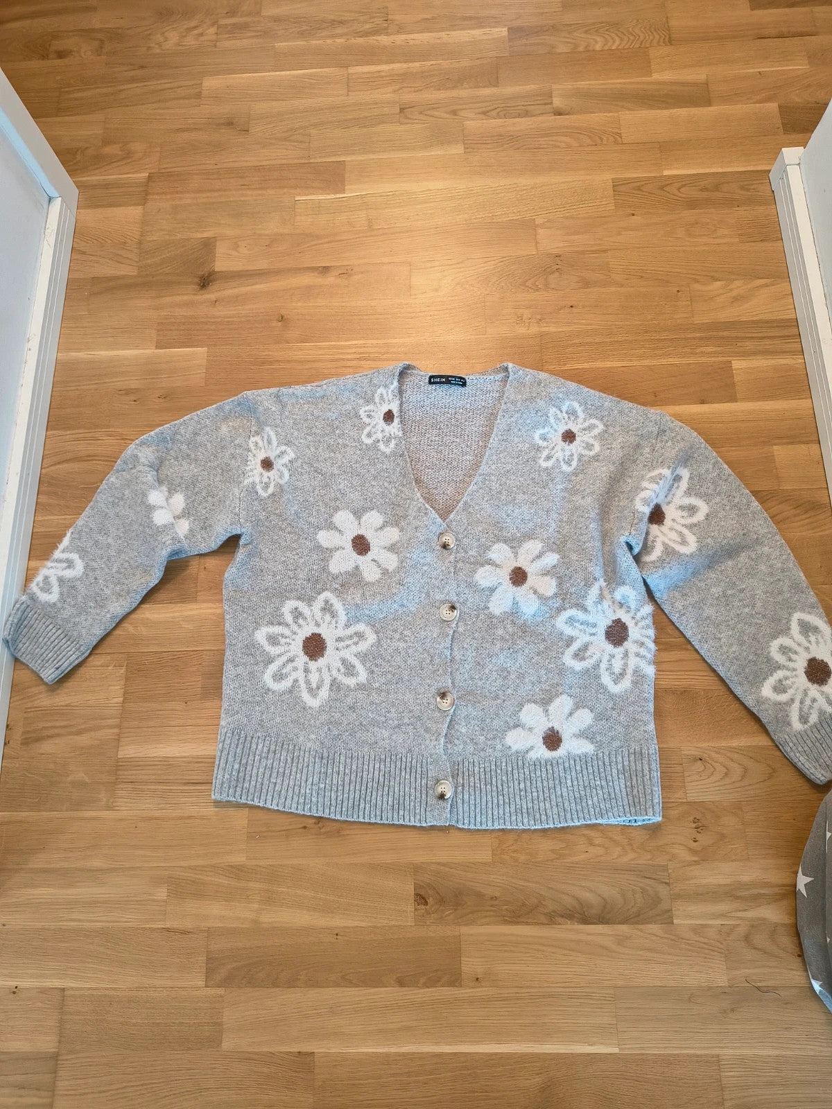 SheIn grey knit cardigan with white-brown floral pattern, V-neck, and button closure.