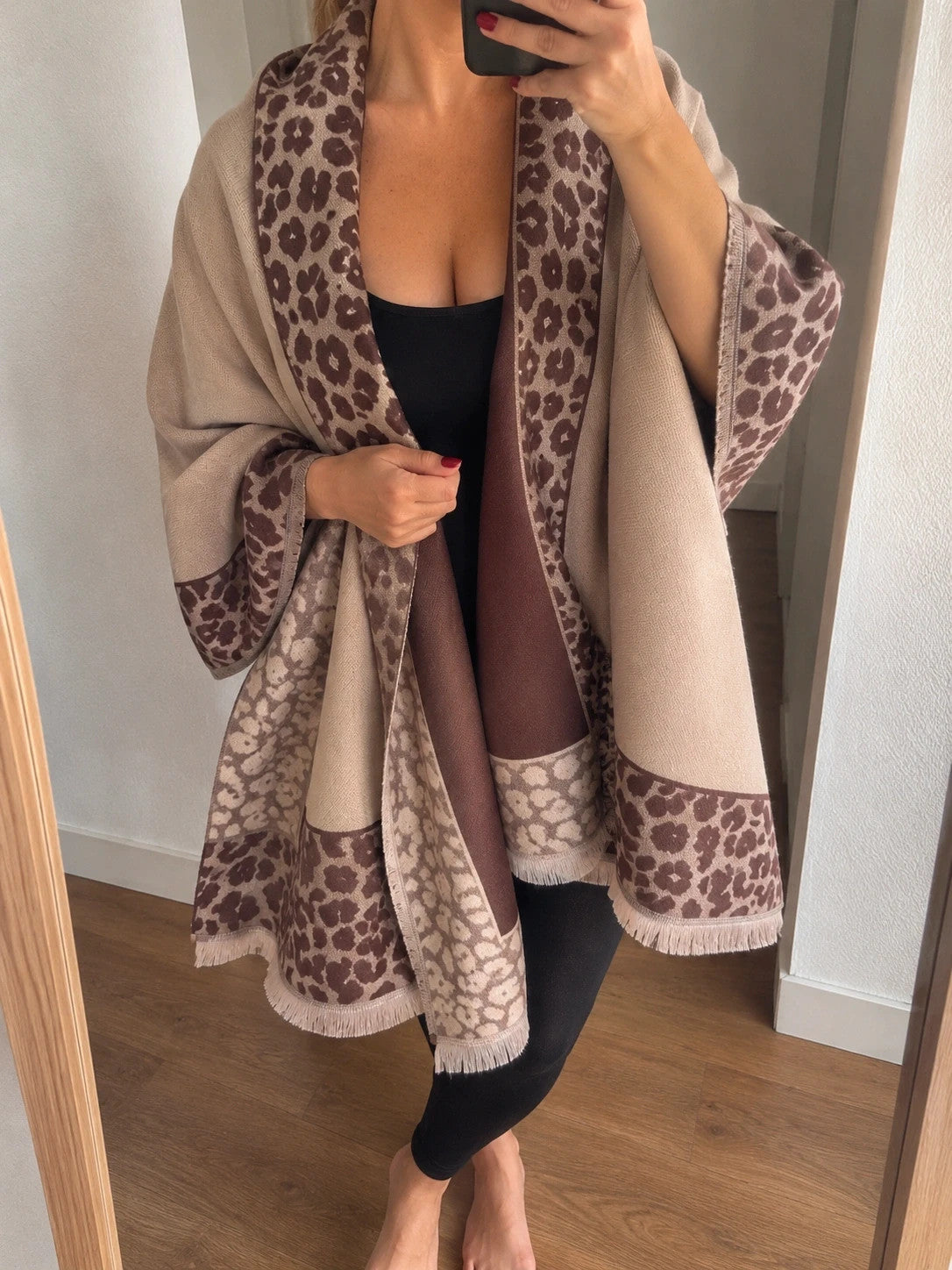 Beige scarf with brown leopard print edges and decorative fringes, reversible design.