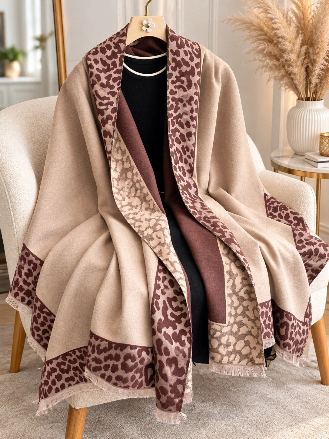 Beige scarf with brown leopard print edges and decorative fringes, reversible design.
