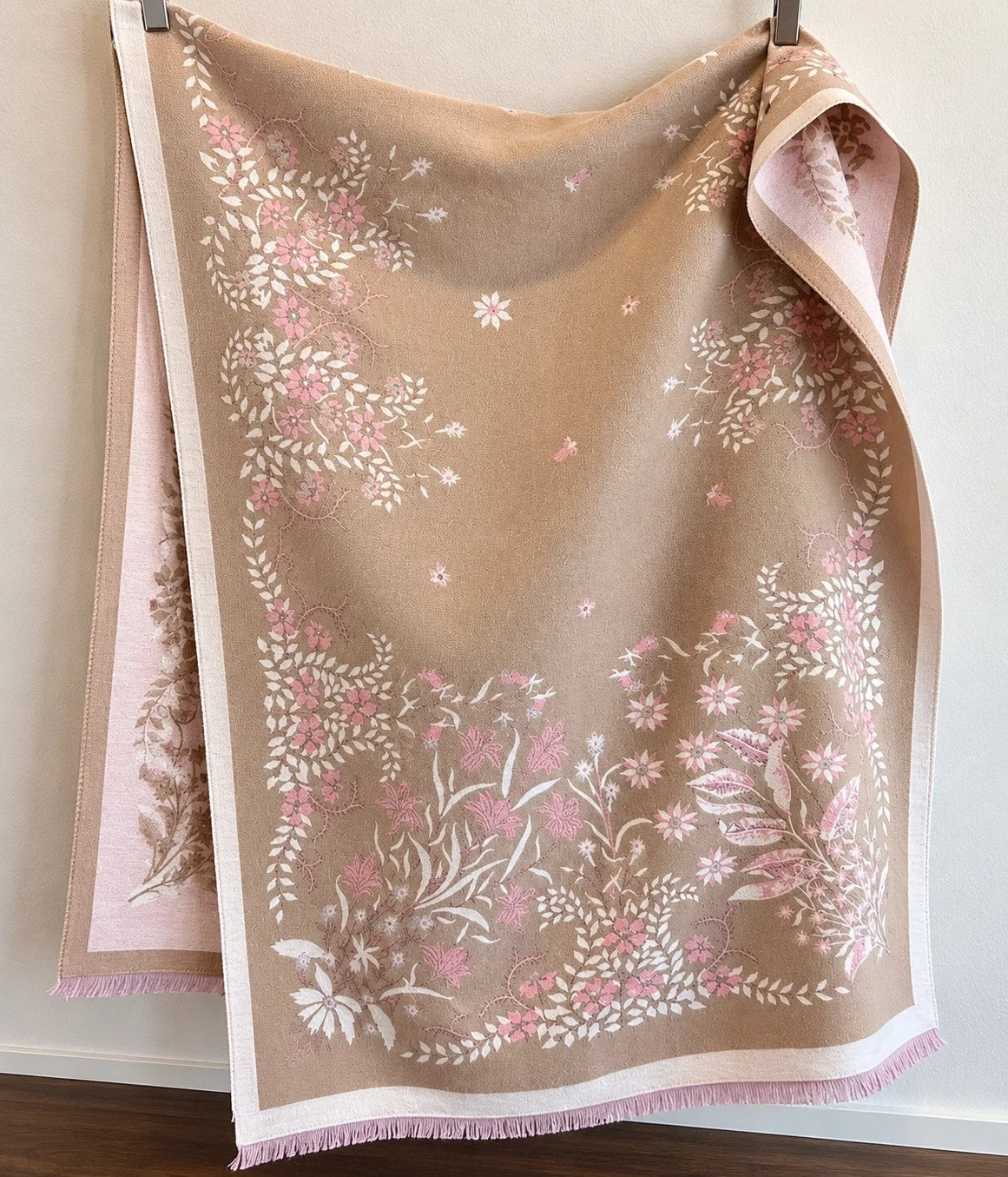 Beige shawl with pink floral pattern, reversible, soft polyester, fringed edges.