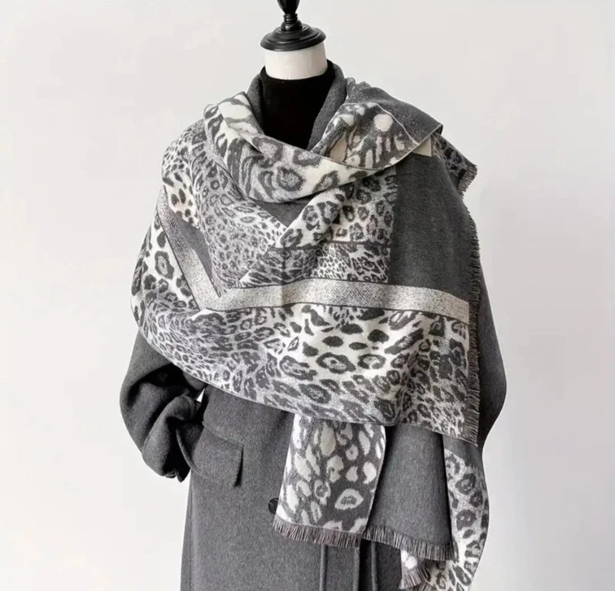 Creme reversible scarf grey and cream with leopard print and geometric patterns, fringed ends.