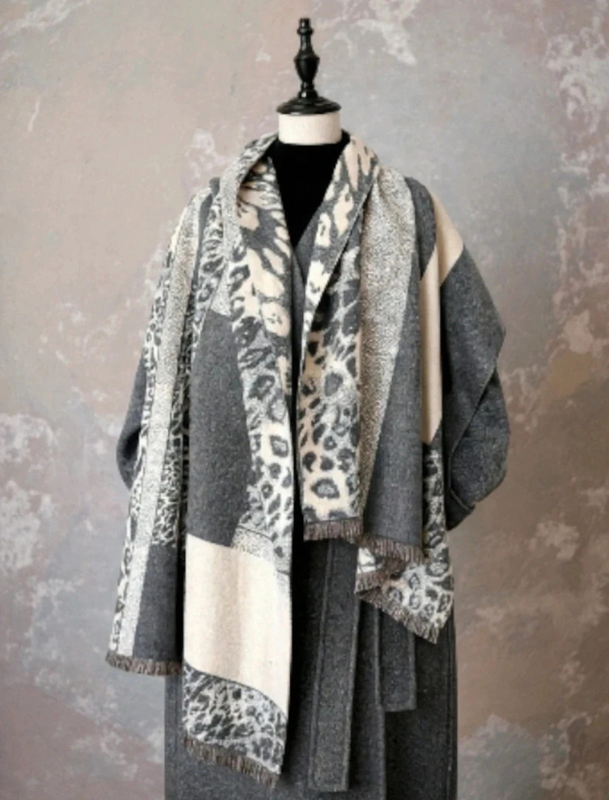 Creme reversible scarf grey and cream with leopard print and geometric patterns, fringed ends.