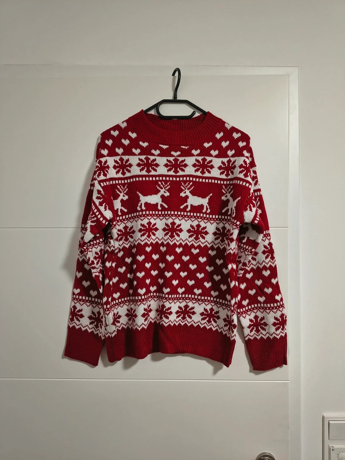 SheIn red and white Christmas sweater with reindeer, snowflakes, and ribbed cuffs.