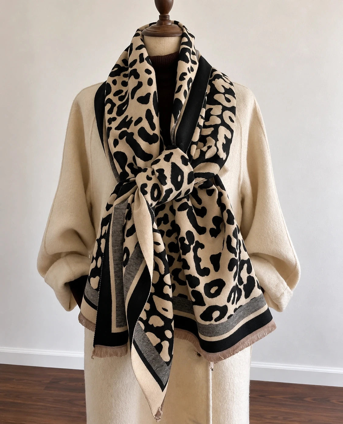 Beige shawl with leopard print, black and cream border, and fine fringes.