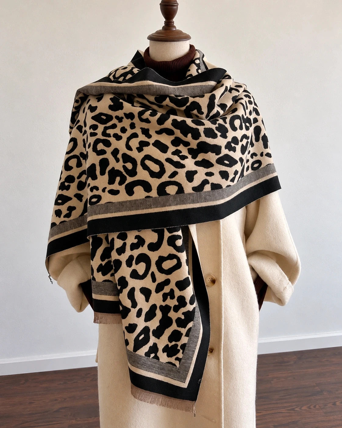 Beige shawl with leopard print, black and cream border, and fine fringes.