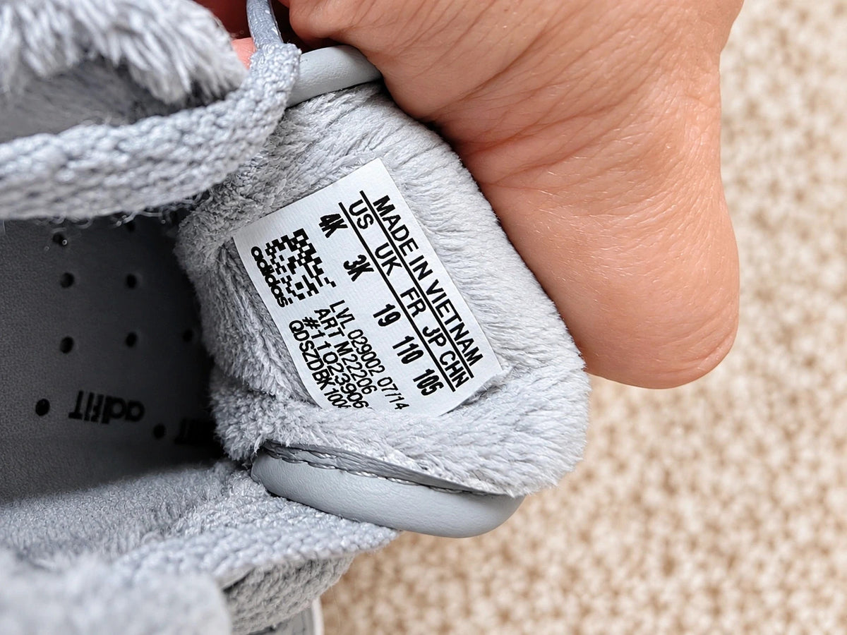 Adidas high top sneakers grey with soft lining, white rubber sole, and logo detail.