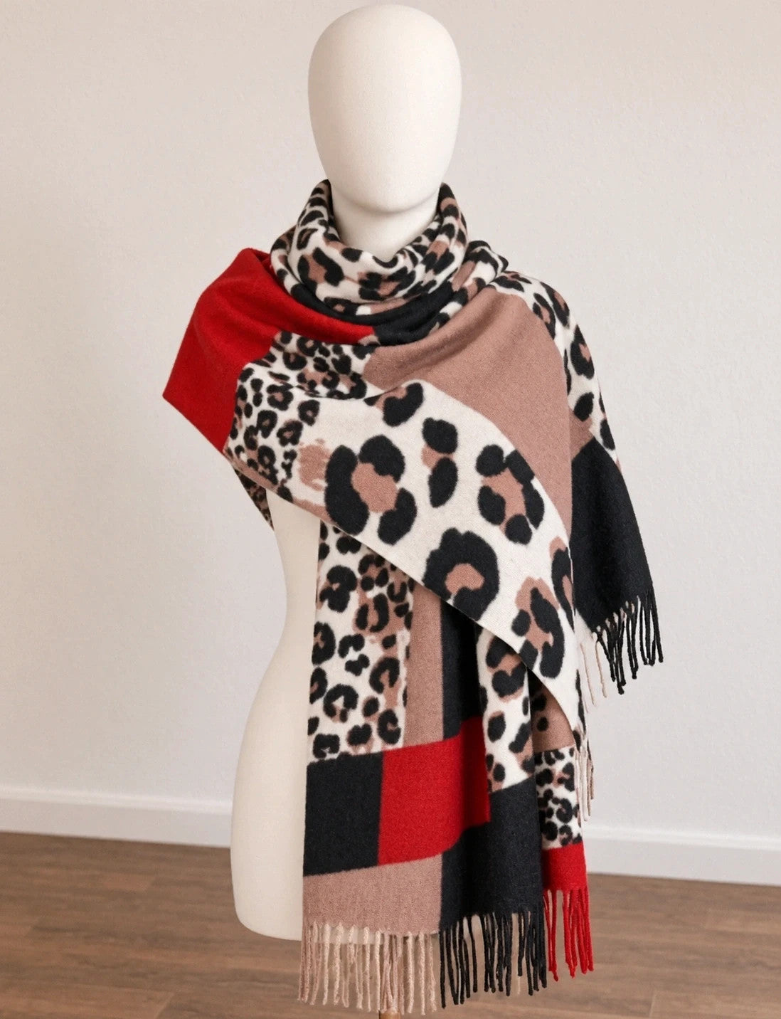 Muster multi shawl leopard print with fringe in red, beige, brown, cream, and black.