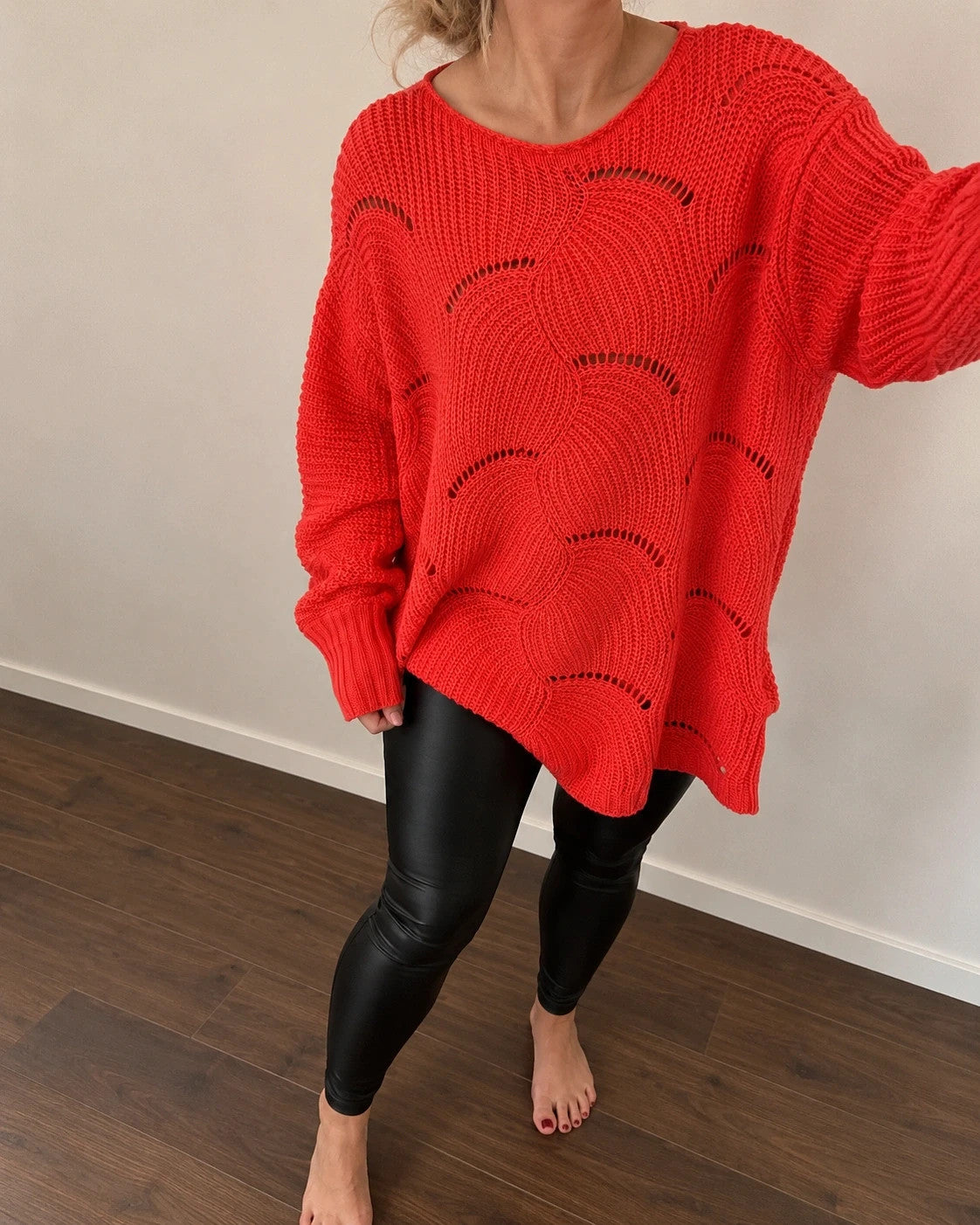 Pullover orange pink oversized sweater with decorative knit pattern and hole details.