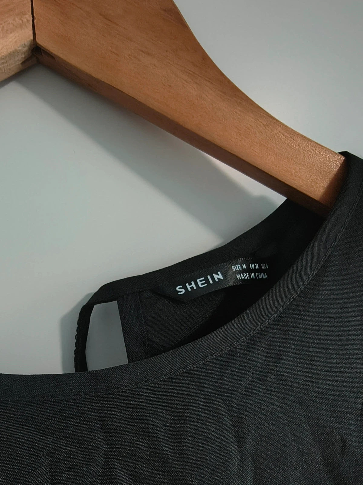 SheIn black oversized A-line dress with layered ruffle sleeves and asymmetrical hem.