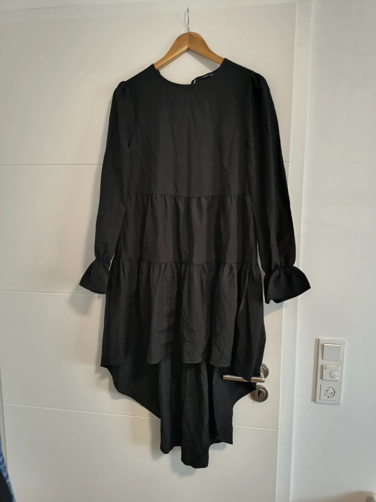 SheIn black oversized A-line dress with layered ruffle sleeves and asymmetrical hem.