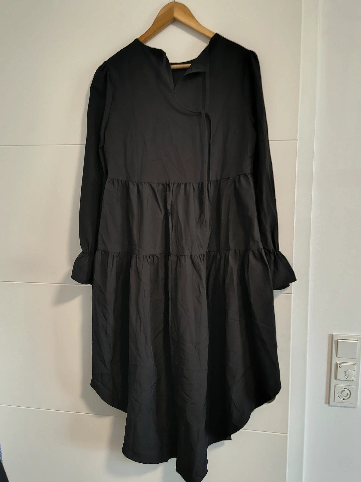 SheIn black oversized A-line dress with layered ruffle sleeves and asymmetrical hem.
