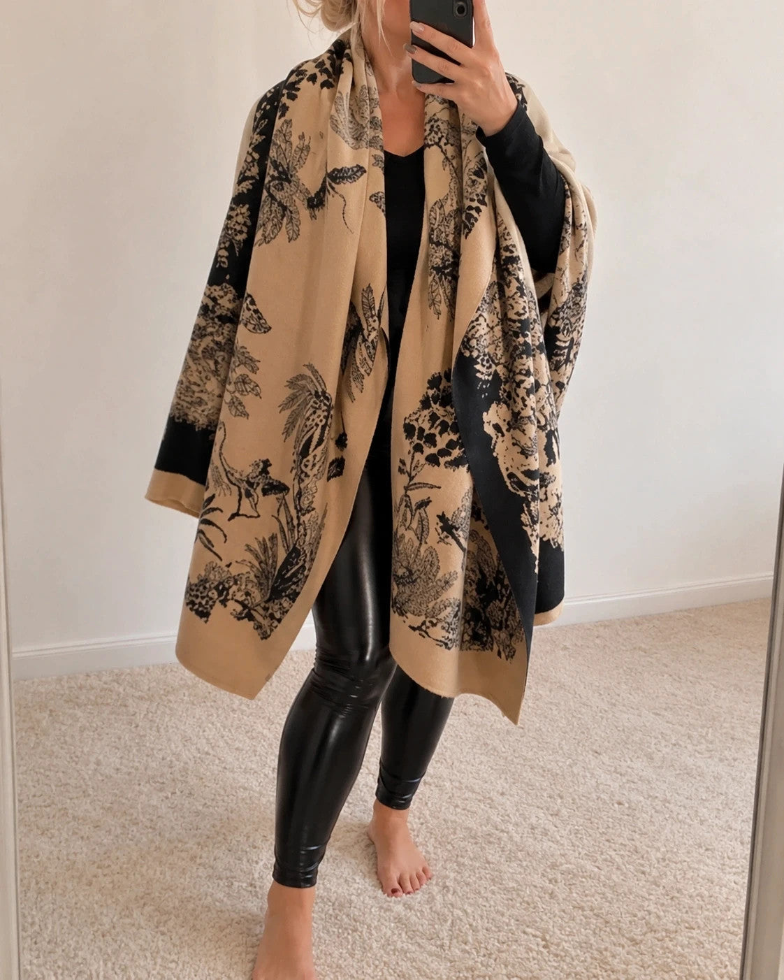 Beige shawl with black floral pattern, soft polyester material, versatile design.