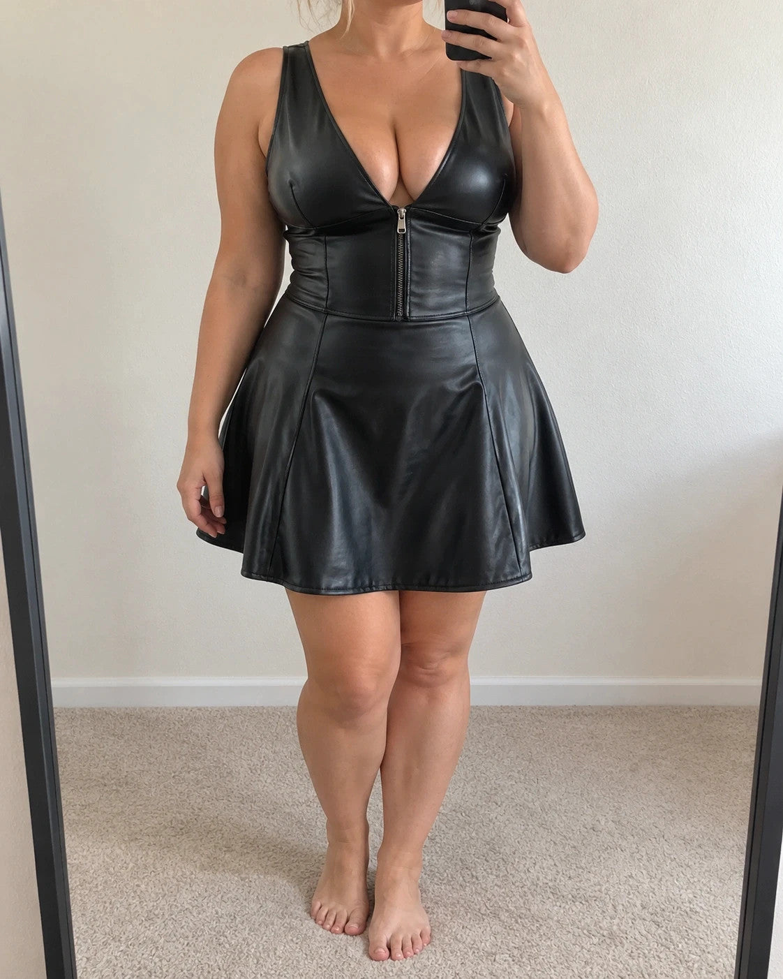 XXL black bandage dress with glossy leather look, deep V-neck, and open back.