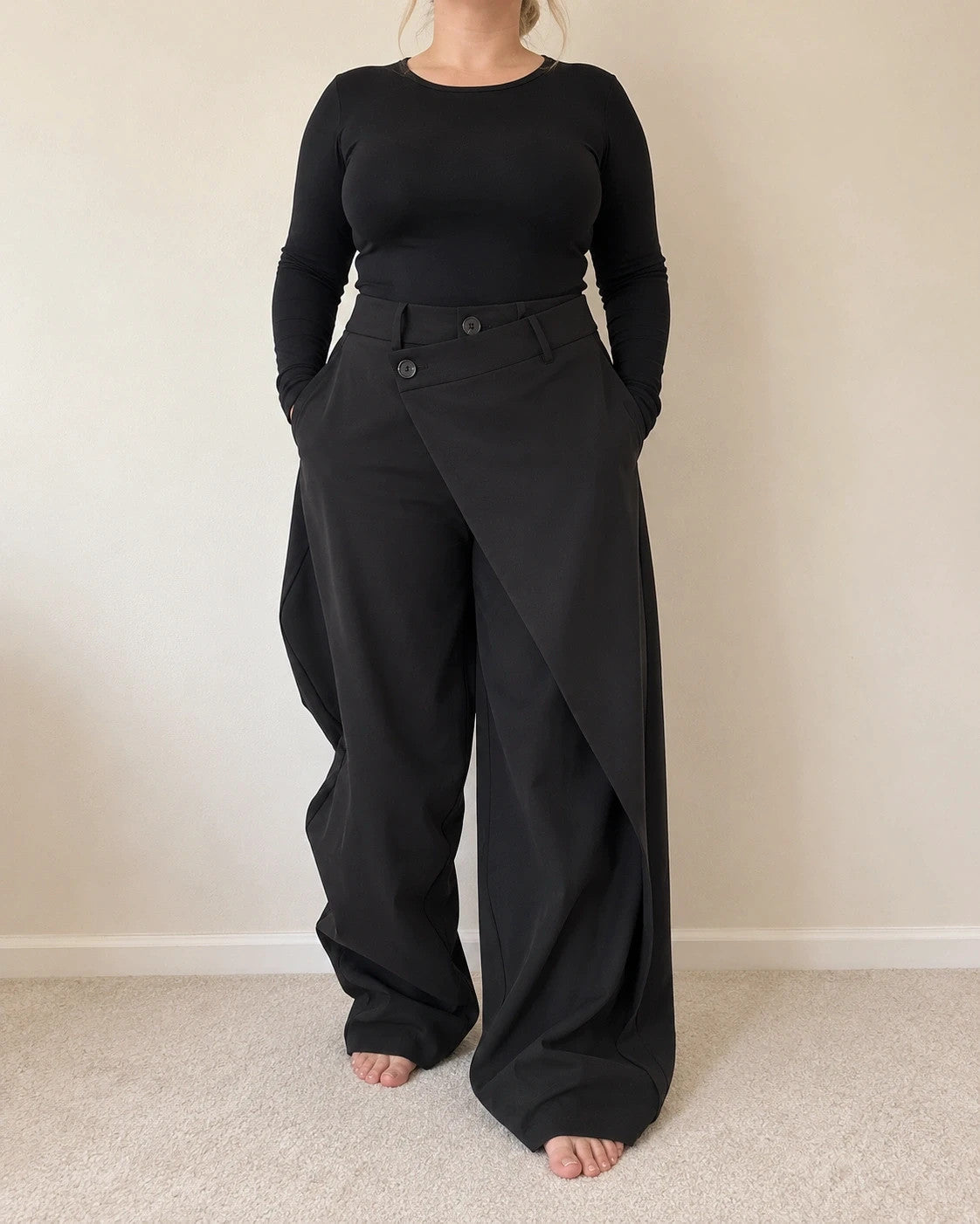 Wide leg black trousers with asymmetrical wrap design and overlapping waistband.