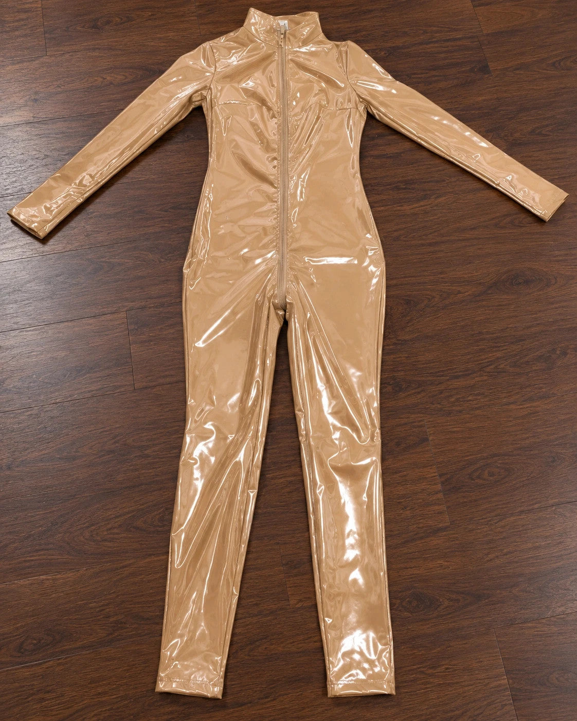 Beige jumpsuit with long sleeves, fitted silhouette, and standing collar.