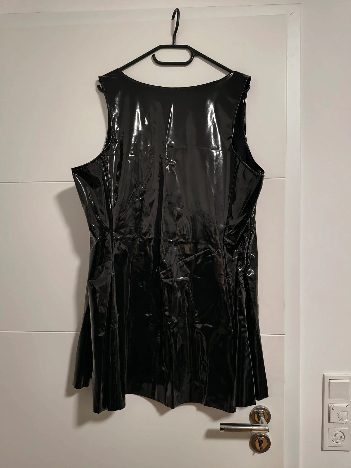 REI black bandage dress glossy wetlook with flared skirt and front zipper detail.