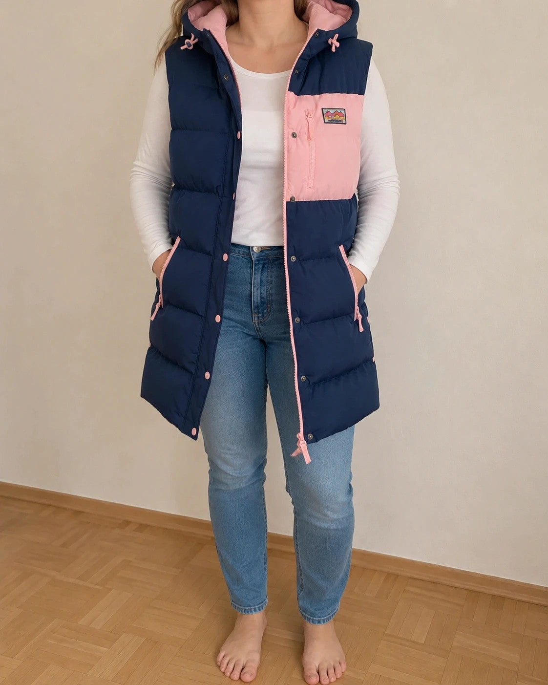 Lagooners navy vest with pink accents, quilted design, logo on chest, hooded.