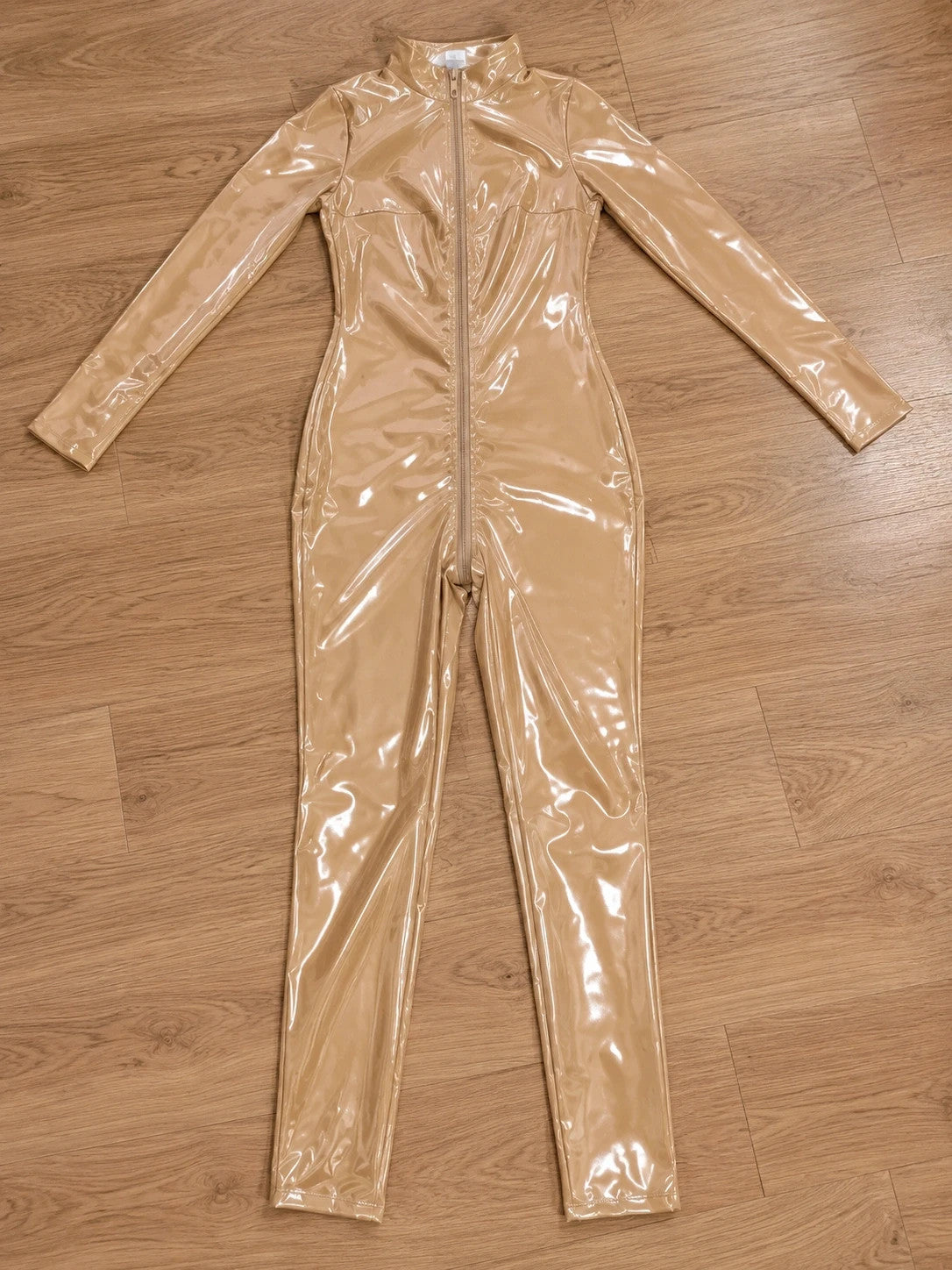 XXL beige jumpsuit with long sleeves, standing collar, and body-hugging fit.