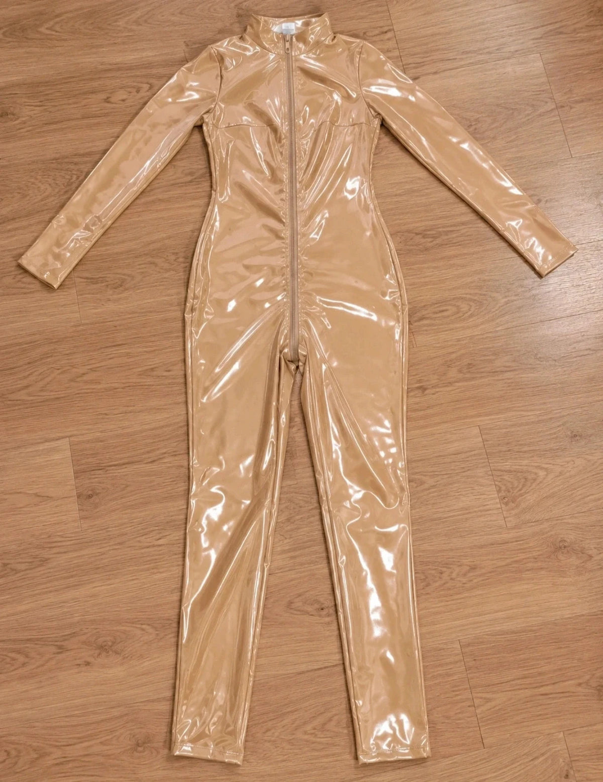 XXL beige jumpsuit with long sleeves, standing collar, and body-hugging fit.