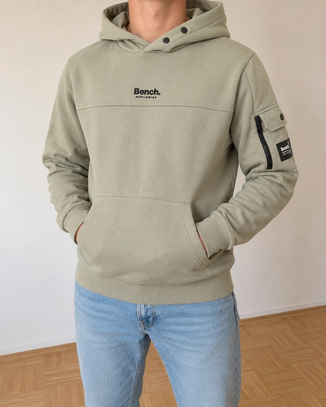 Bench green hoodie with rubber logo, kangaroo pocket, and thumbholes.
