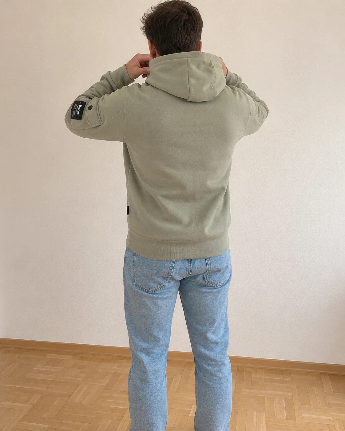 Bench green hoodie with rubber logo, kangaroo pocket, and thumbholes.