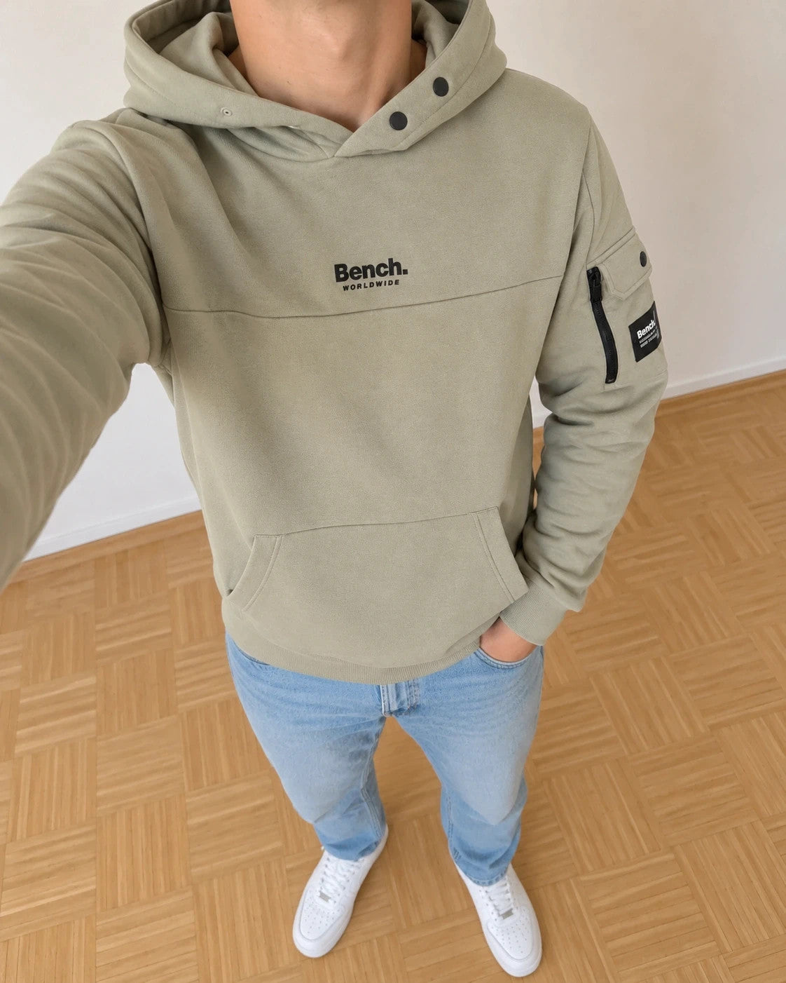 Bench green hoodie with rubber logo, kangaroo pocket, and thumbholes.