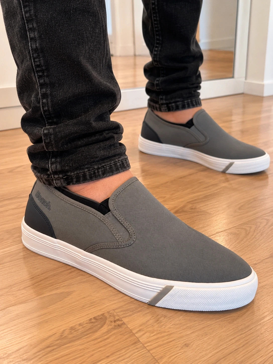 Bench grey slip-on trainers with white rubber sole and dark heel accents.