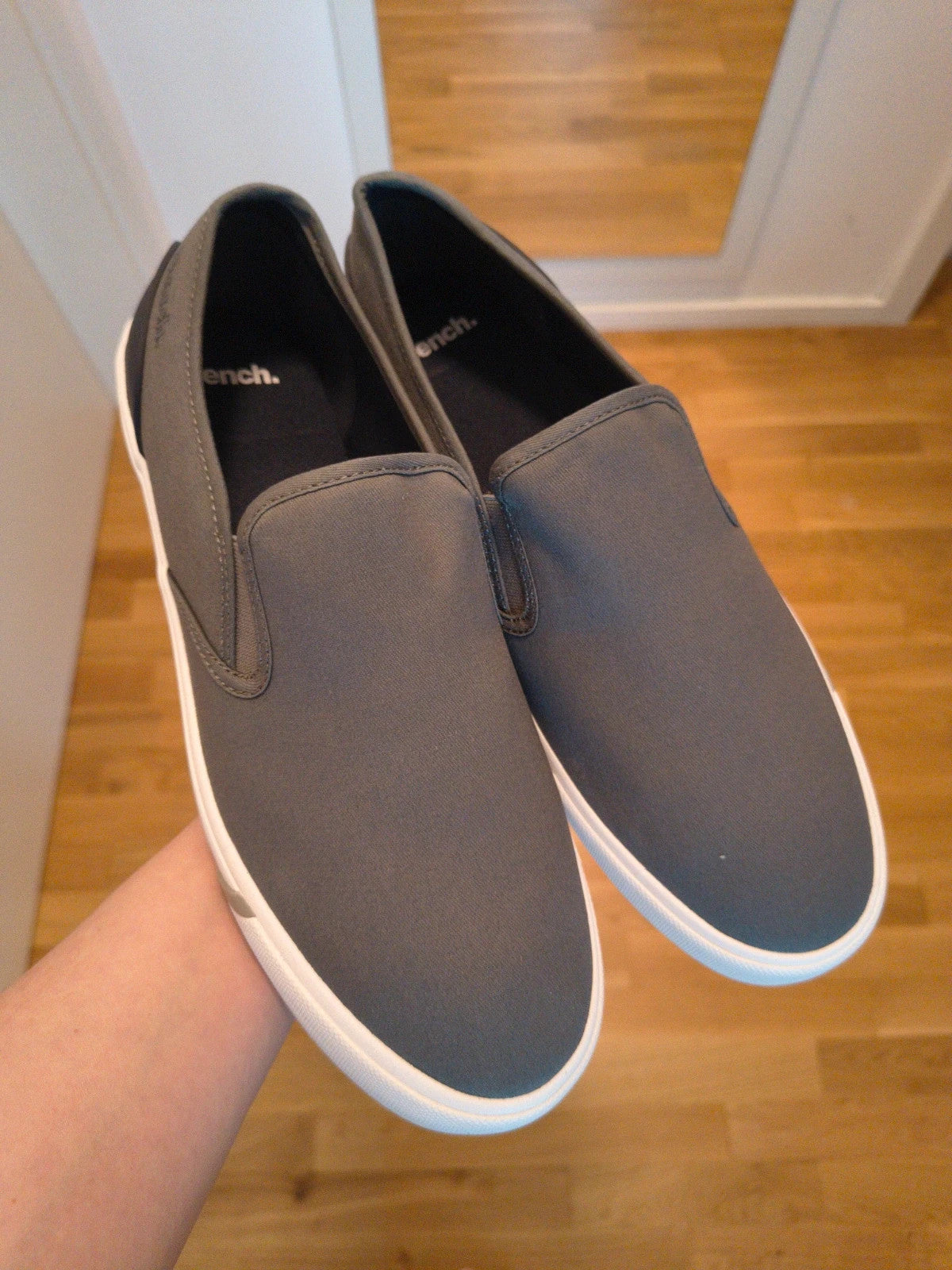 Bench grey slip-on trainers with white rubber sole and dark heel accents.