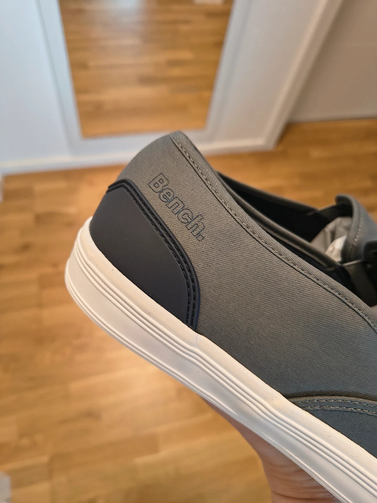 Bench grey slip-on trainers with white rubber sole and dark heel accents.