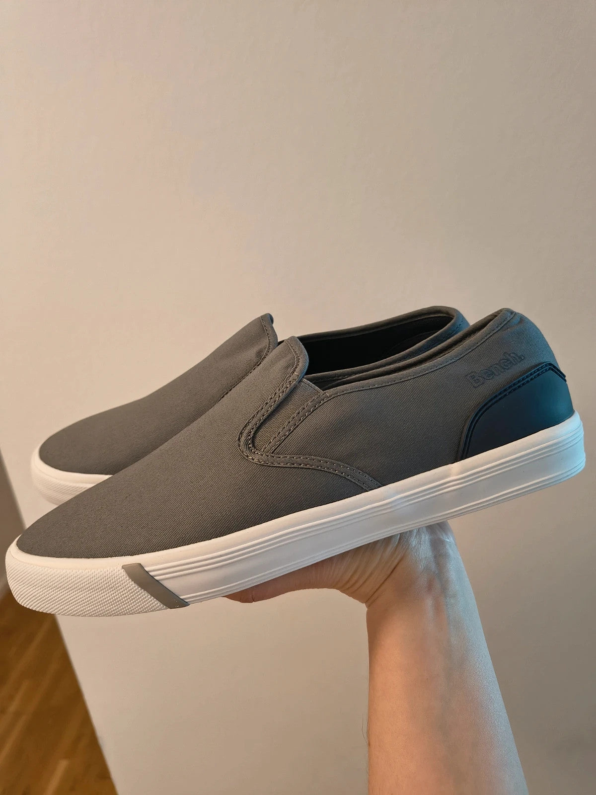 Bench grey slip-on trainers with white rubber sole and dark heel accents.