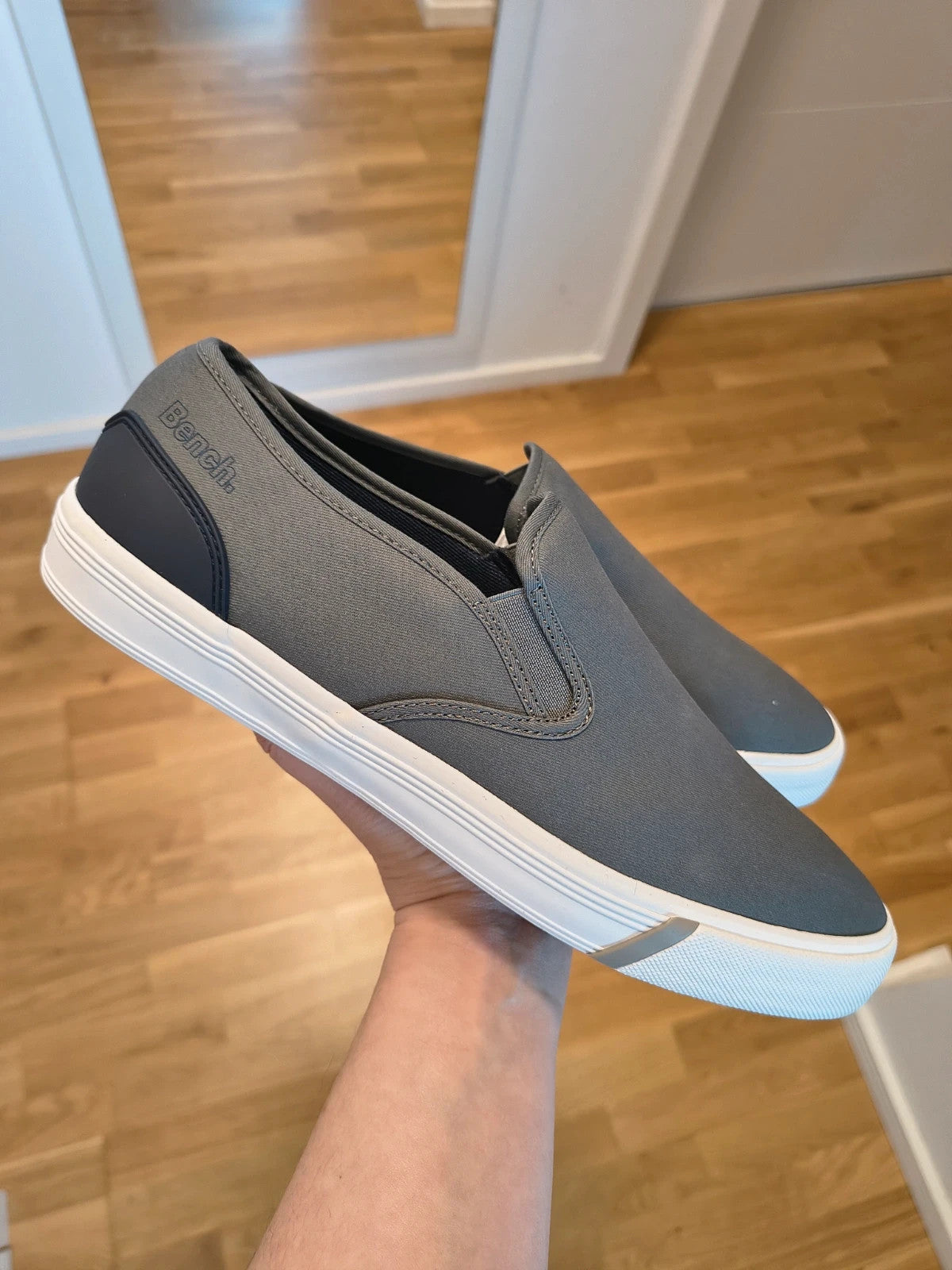 Bench grey slip-on trainers with white rubber sole and dark heel accents.