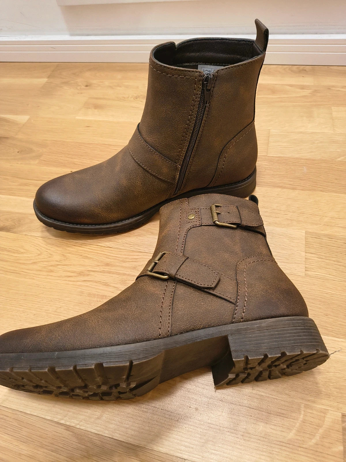 Deakins brown biker boots with antique metal buckles and side zipper, robust leather look.