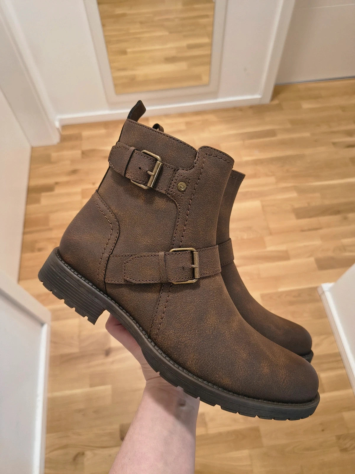 Deakins brown biker boots with antique metal buckles and side zipper, robust leather look.