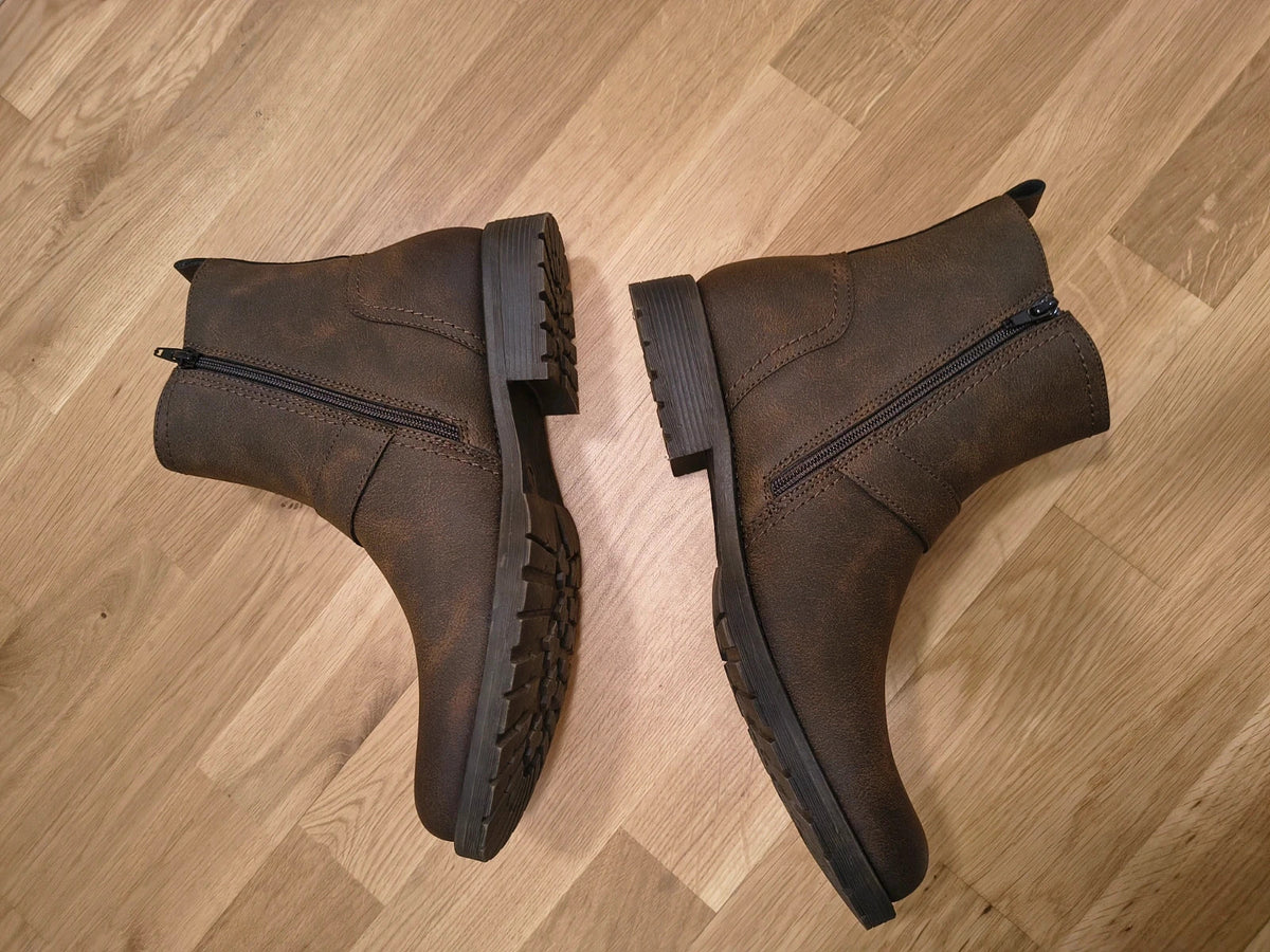 Deakins brown biker boots with antique metal buckles and side zipper, robust leather look.