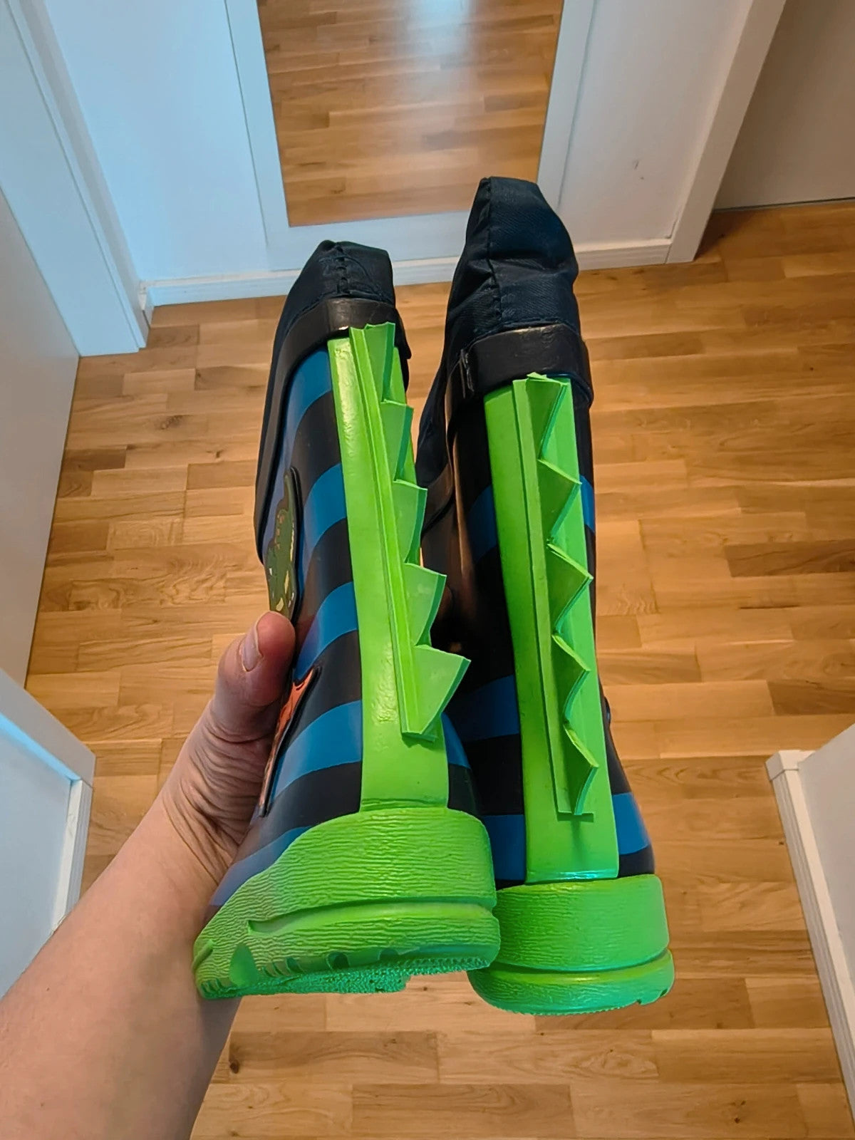 Beck blue and green children's rain boots with dinosaur patterns and rubber sole.