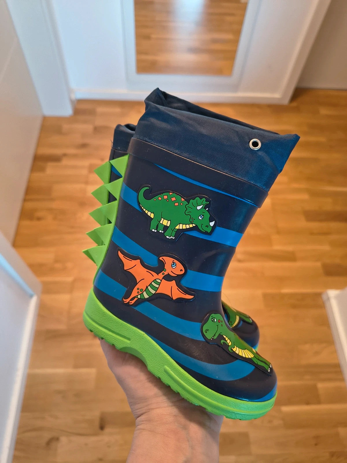 Beck blue and green children's rain boots with dinosaur patterns and rubber sole.
