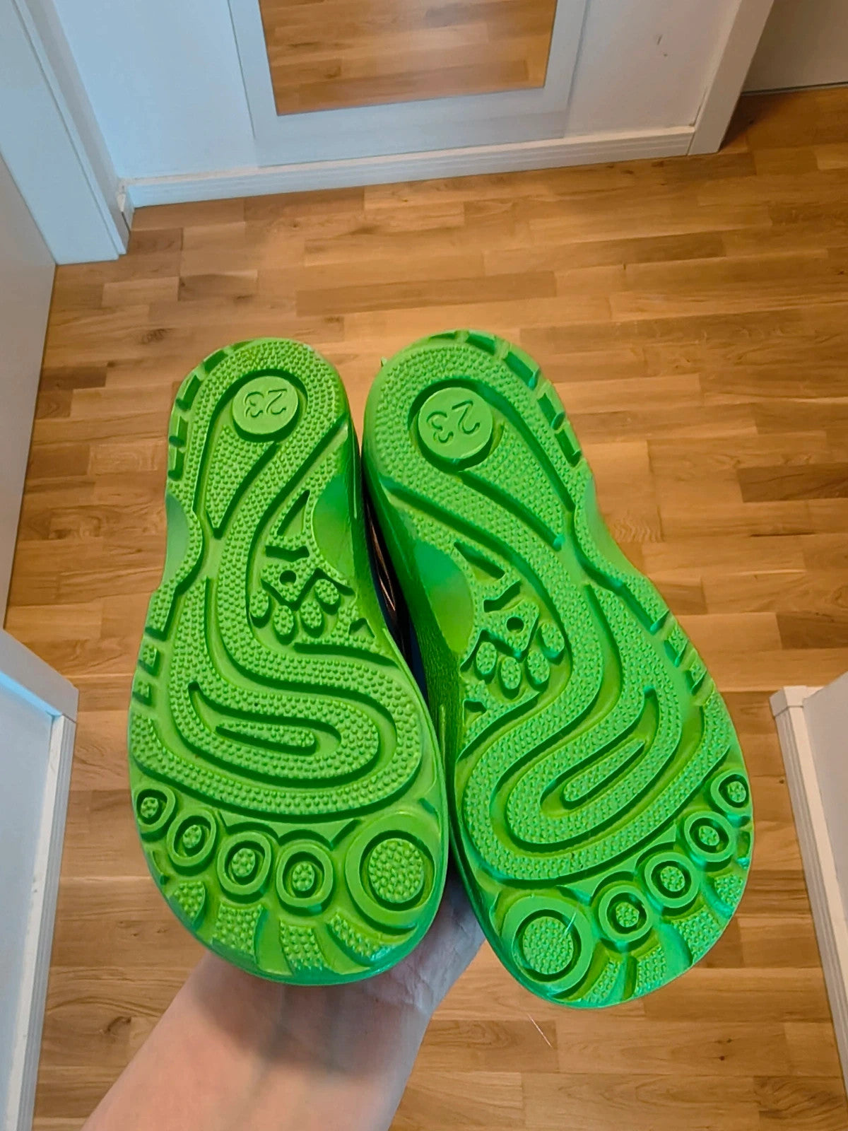 Beck blue and green children's rain boots with dinosaur patterns and rubber sole.