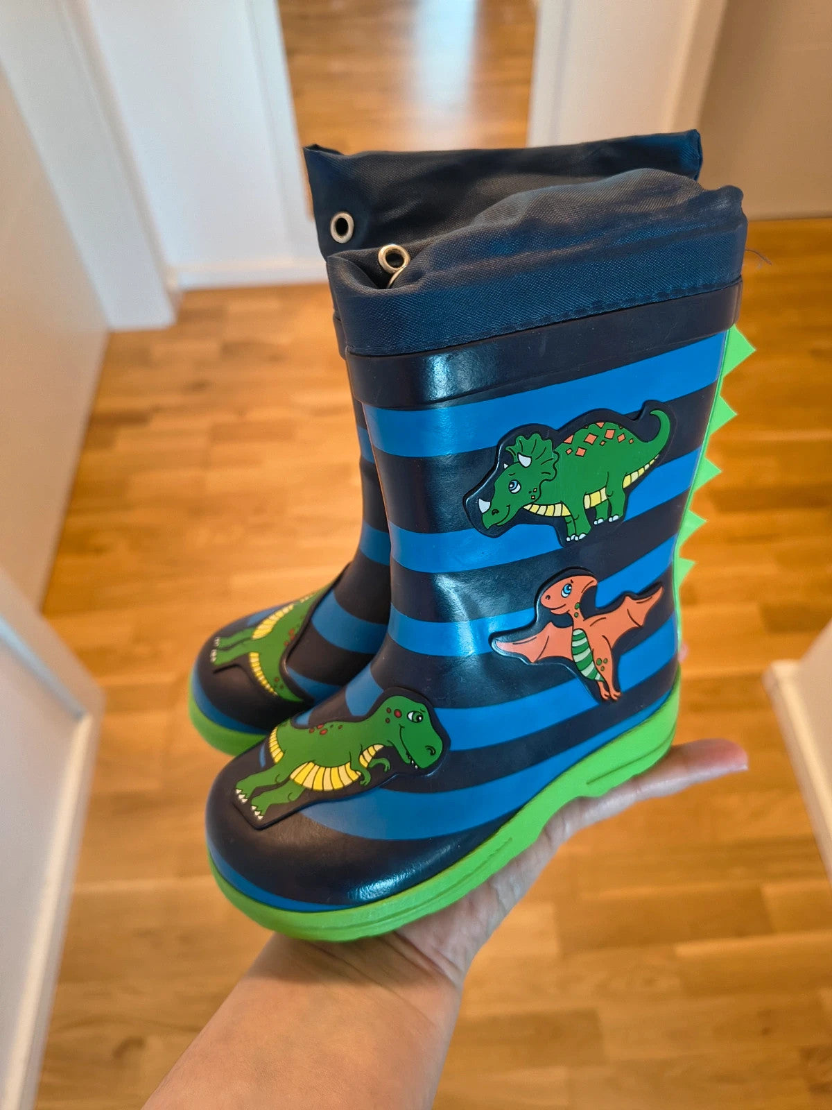 Beck blue and green children's rain boots with dinosaur patterns and rubber sole.