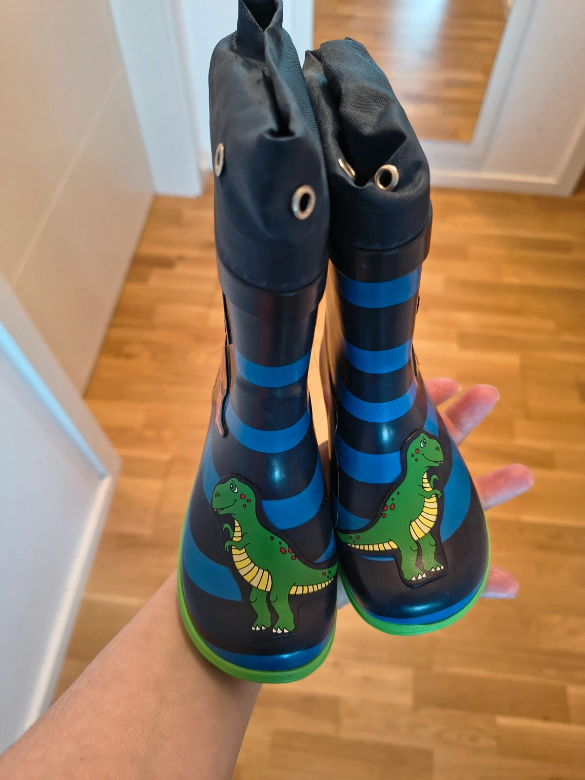 Beck blue and green children's rain boots with dinosaur patterns and rubber sole.
