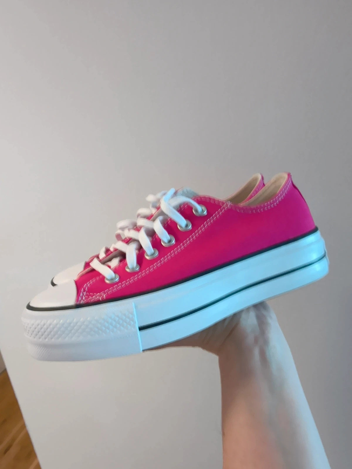 Converse pink Chuck Taylor All Star Lift Platform sneakers with white sole and logo.