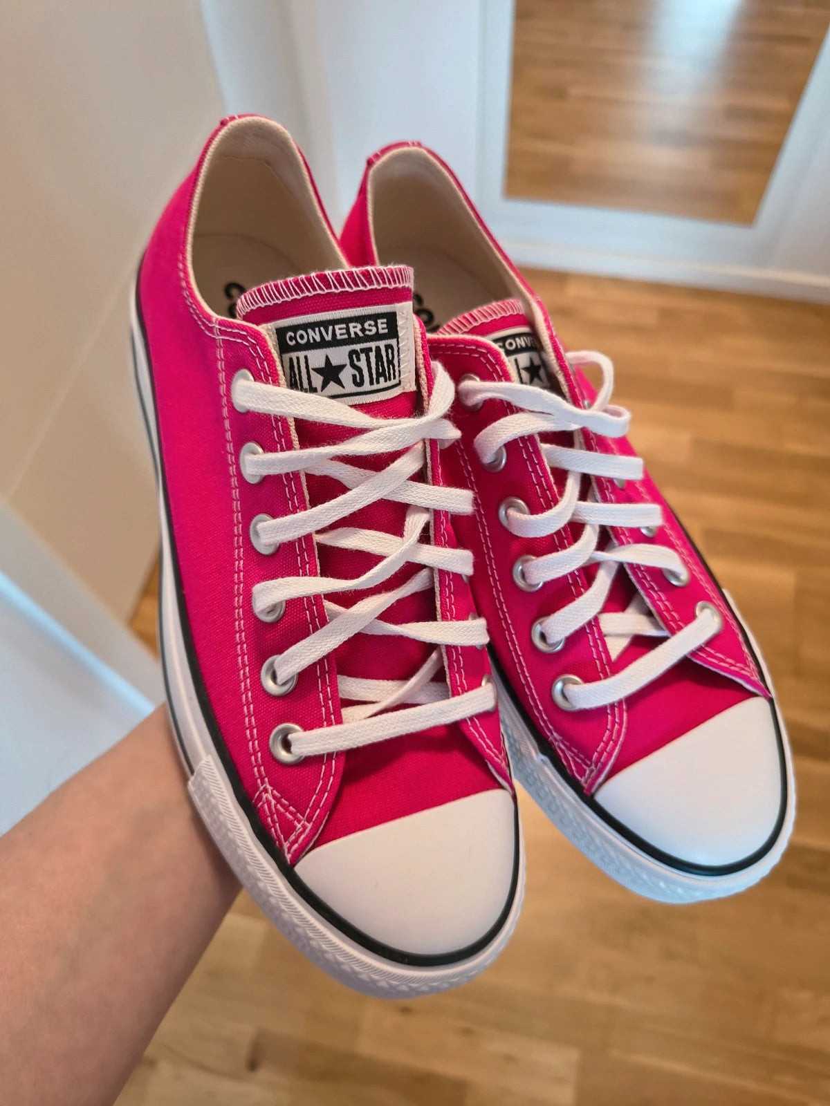 Converse pink Chuck Taylor All Star Lift Platform sneakers with white sole and logo.