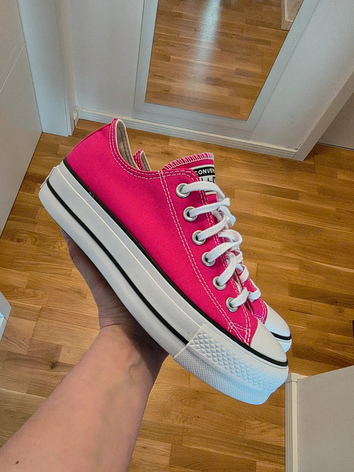 Converse pink Chuck Taylor All Star Lift Platform sneakers with white sole and logo.